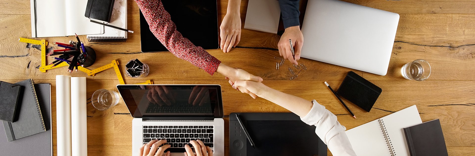 Business men and women shaking hands together